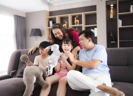A mother playing with her children in their home