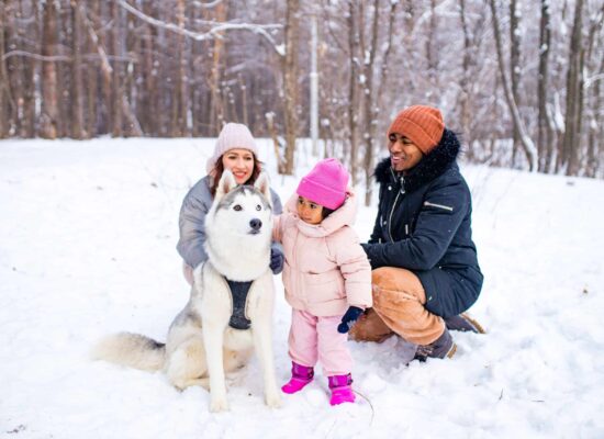 Winter family moment with pet outdoors