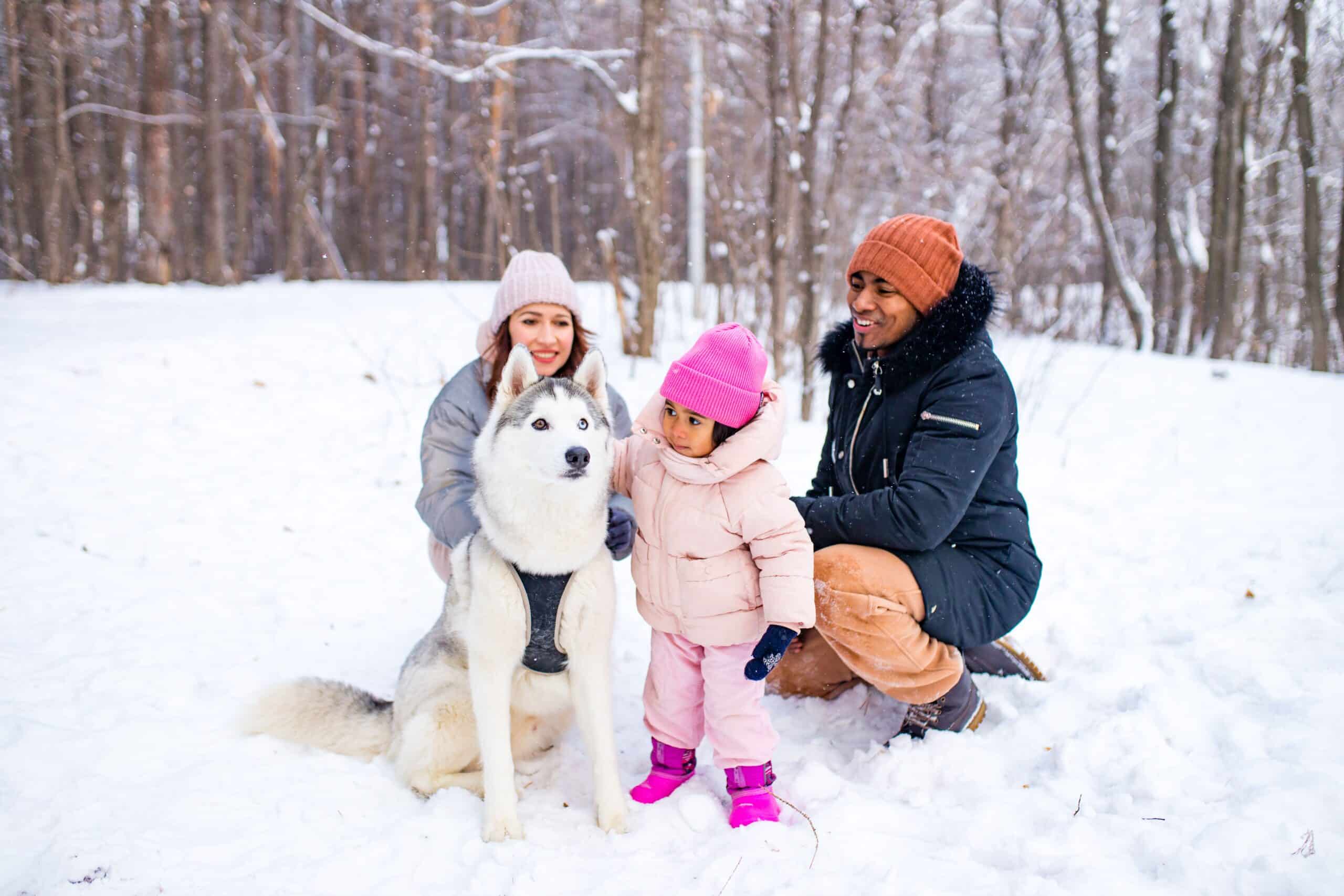 Winter family moment with pet outdoors