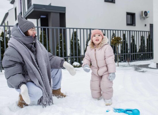 Family enjoying snowy winter yard, pest-free