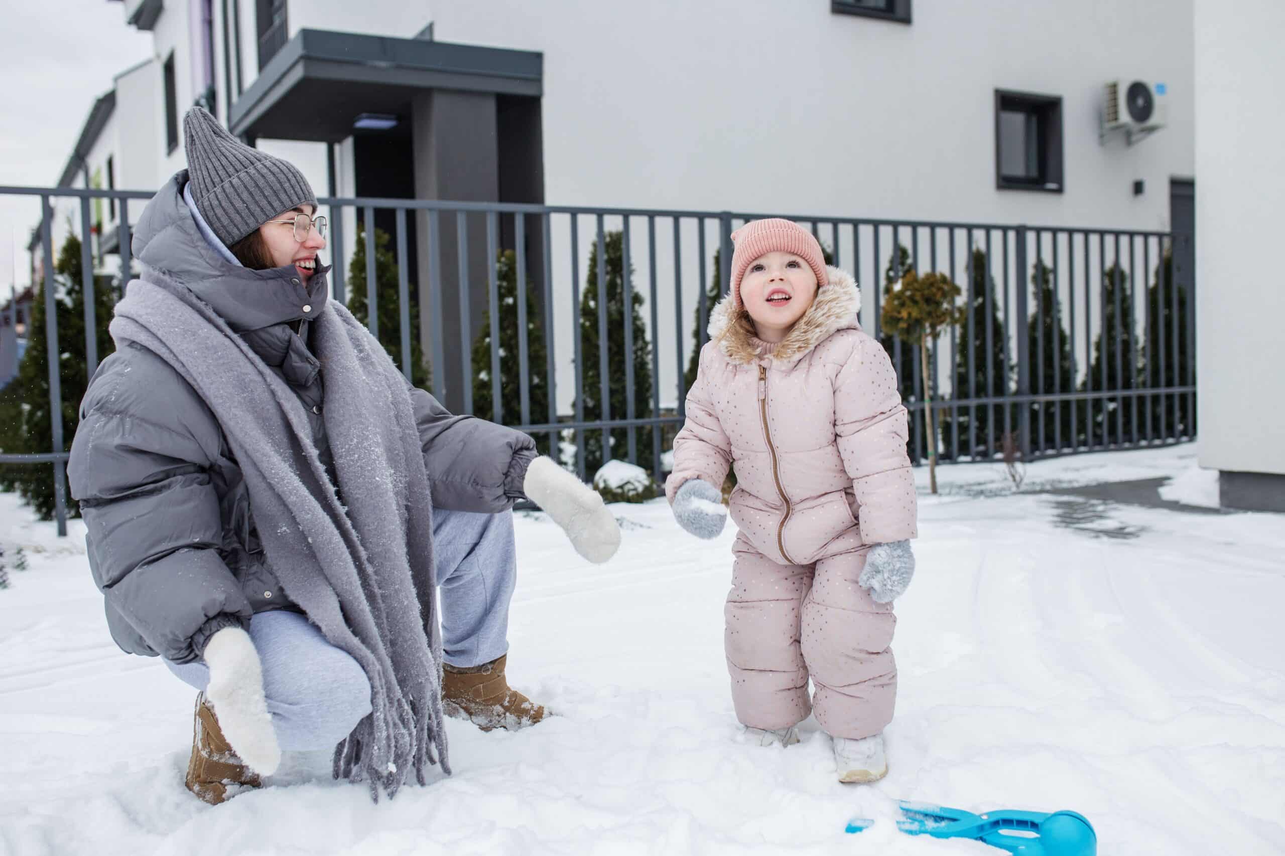Family enjoying snowy winter yard, pest-free